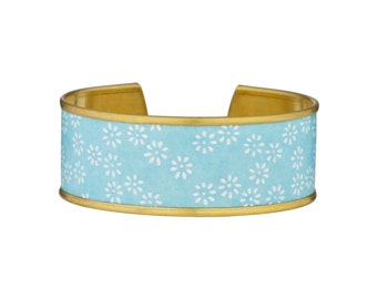Brass cuff bracelet and blue Japanese paper with white flowers