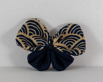 Butterfly brooch in Japanese fabric with small blue waves on an ecru background