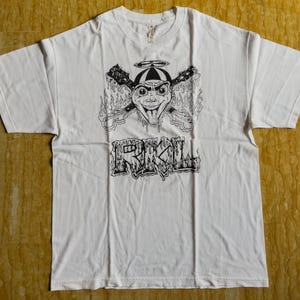 May include: White t-shirt with a black and white graphic of a cartoon character with a halo and the word "RIKKILL" printed below.
