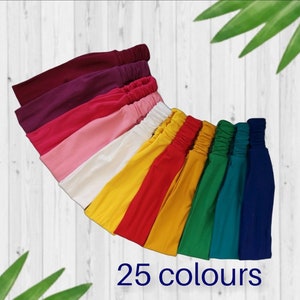 May include: A collection of 25 colorful headbands in various shades of pink, red, yellow, green, and blue. The headbands are made of a soft, stretchy fabric and are perfect for adding a pop of color to any outfit.