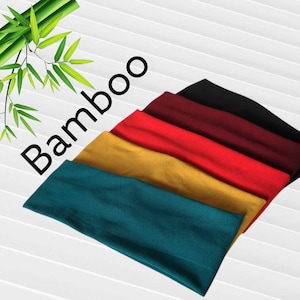 May include: A selection of headbands in teal, gold, red, burgundy, and black. The word "Bamboo" is printed in black on the image. Bamboo stalks and leaves are in the upper left corner.