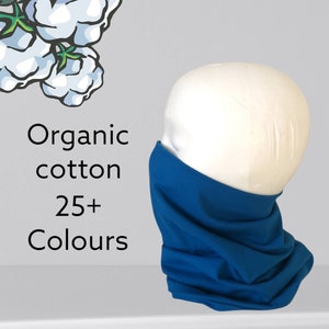 May include: A blue fabric neck gaiter made from organic cotton. The neck gaiter is on a white mannequin head. The text "Organic cotton 25+ Colours" is visible in the image.