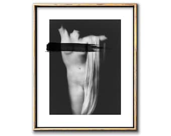 May include: Black and white photograph of a nude figure with a black brushstroke across the chest. The figure is standing with a white cloth draped around them.