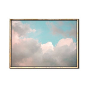 May include: A framed print of a pastel pink and blue sky with fluffy white clouds.