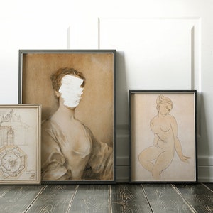 May include: Three framed drawings on a wooden floor. The drawing on the left is a black and white architectural design. The drawing in the center is a sepia toned portrait of a woman with her face obscured by white paint. The drawing on the right is a sepia toned sketch of a nude woman sitting down.