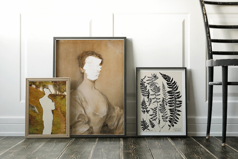 May include: Three framed prints on a white wall with a black chair in the foreground. The print on the left is a landscape with a person standing in the middle. The print in the centre is a portrait of a woman with her face obscured by white paint. The print on the right is a black and white botanical illustration of ferns.