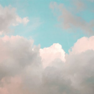 May include: A soft, pastel blue sky with fluffy white clouds. The clouds are clustered together in the lower half of the image, creating a sense of depth and dimension.