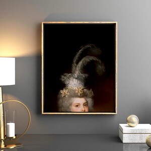 May include: A framed portrait of a person with powdered hair and a feathered headdress. The artwork is in a gold frame and hangs on a grey wall. The image is part of a home decor collection.