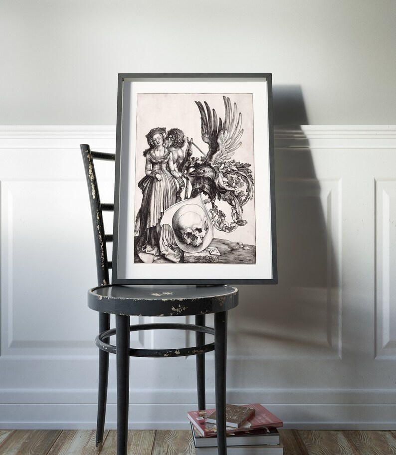 May include: Black and white print of a Renaissance-era engraving depicting a couple standing next to a skull and a winged creature. The print is framed in a black frame and is hanging on a wall.