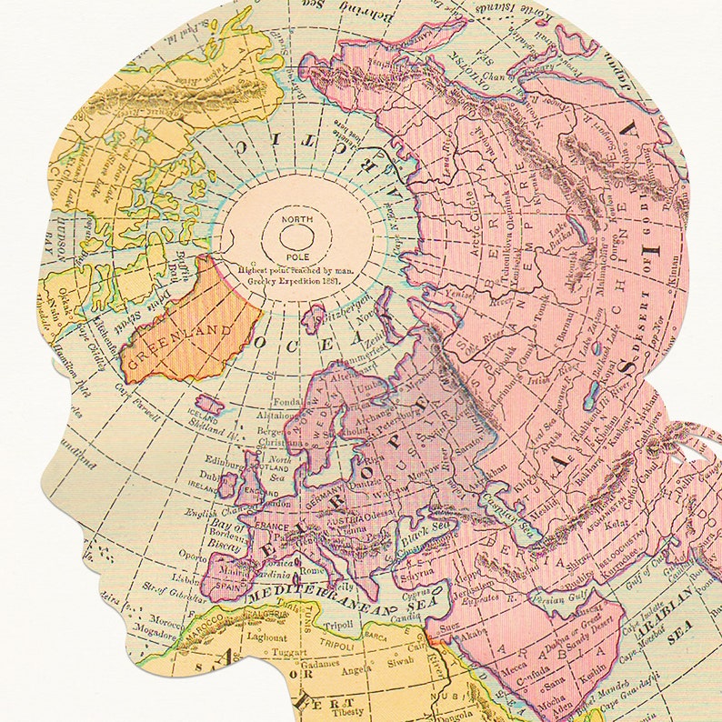 May include: A vintage map of the world with the North Pole at the center. The map is cut out in the shape of a person's head, with the North Pole representing the brain. The map shows the continents of North America, Europe, Asia, and Africa.