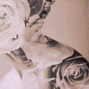 May include: A close-up of a bouquet of roses. The roses are in shades of white and brown, and the petals are soft and delicate. The roses are arranged in a cluster, and the stems are not visible.
