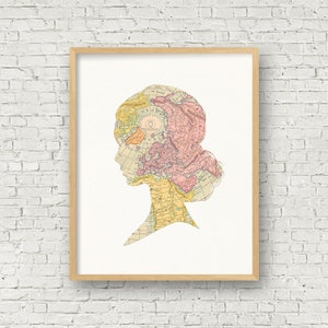 May include: A framed print of a silhouette of a person's head with a vintage world map overlayed on the silhouette. The map is in shades of pink, yellow, and blue.