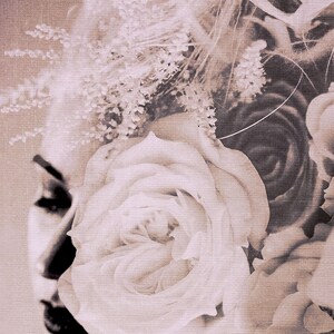 May include: A close-up of a white rose with a soft, textured background. The rose is in focus, while the background is blurred. The image has a vintage, faded look.