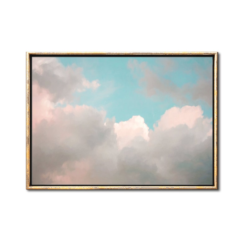 May include: A framed print of a pastel pink and blue sky with fluffy white clouds.
