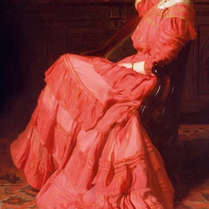 May include: A woman in a long, flowing, pink dress sits in a chair. The dress has many layers of ruffles and is very detailed. The woman is looking off to the side and has a relaxed expression.