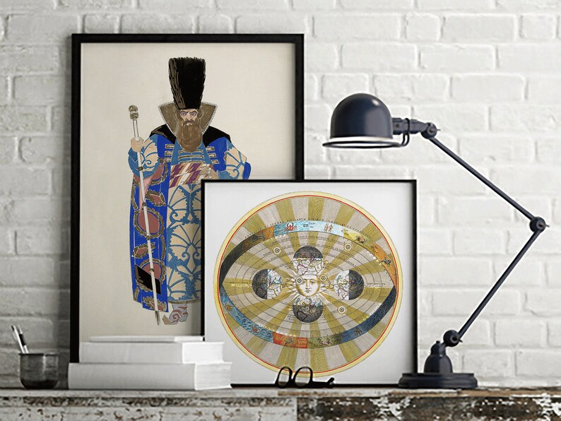 May include: Two framed prints on a white brick wall. The print on the left features a man in a blue and gold patterned robe holding a staff. The print on the right features a circular illustration of a geocentric model of the solar system.