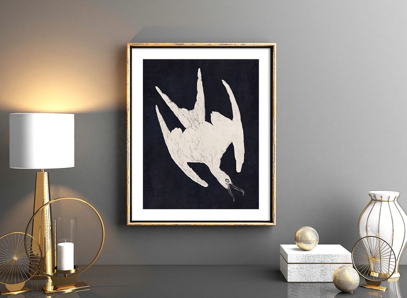 May include: A framed print of a white bird with its wings spread out against a dark blue background. The bird is depicted in a stylized, almost abstract manner.