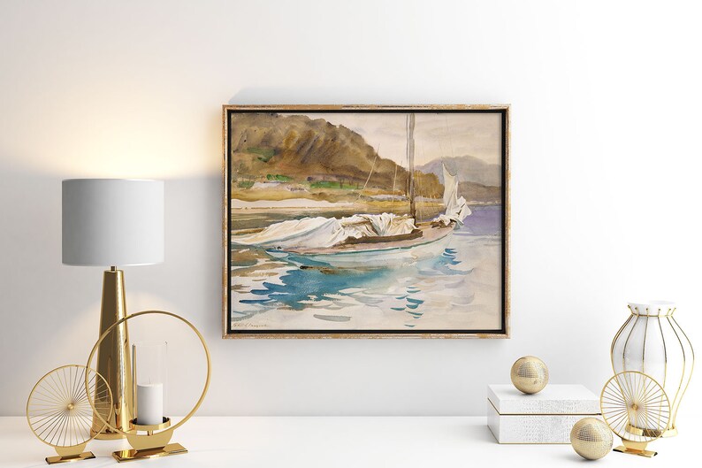 May include: A framed watercolor painting of a sailboat with white sails docked in a body of water. The water is a light blue color and the sky is a light gray color. The background of the painting is a mountain range.
