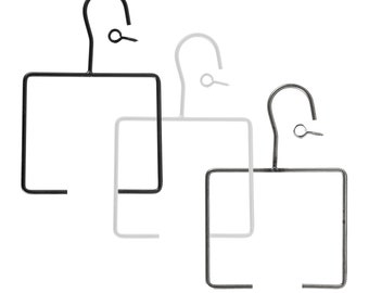 May include: Three metal hangers with square bases and hooks. The hangers are black, silver, and gray.