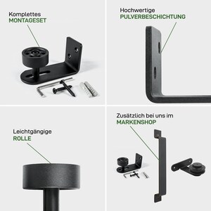 May include: Black metal hardware kit for a sliding barn door. The kit includes a roller, a bracket, and mounting screws. The hardware is powder coated for durability. The text "Komplettes MONTAGESET" is visible in the image.