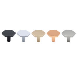 May include: Five hexagonal cabinet knobs in different finishes: black, white, gold, rose gold, and silver.