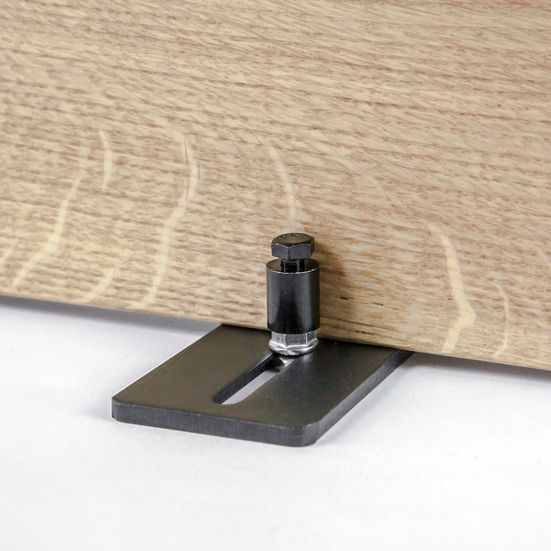 May include: Black metal shelf bracket with a black adjustable support post. The bracket has a slot for the post to slide through and a screw to secure it in place.