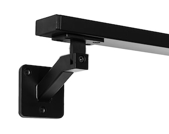 May include: A black metal wall-mounted shelf bracket. The bracket features a square base with screw holes, an angled support arm, and a horizontal shelf support. The design is minimalist and modern, suitable for various home decor styles.