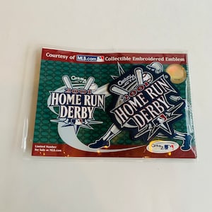 May include: Two embroidered patches featuring the 2001 Home Run Derby logo. The patches are blue, white, and red with silver accents. The text on the patches reads "Century 21 2001 Home Run Derby".