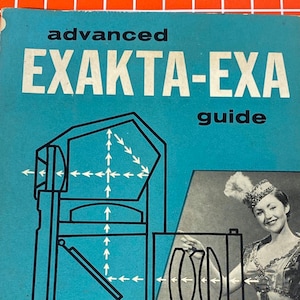 May include: A blue and white book titled "advanced  EXAKTA-EXA guide" by Dr. Kenneth S. Tydings. The book is part of "THE MODERN CAMERA GUIDE SERIES". The cover features a diagram of a camera and a woman in a circus costume.