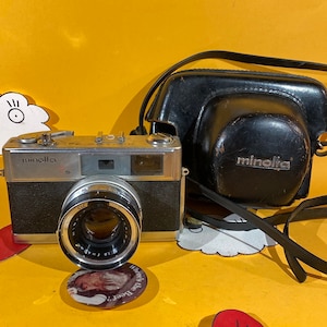 Vintage MINOLTA 7s Rangefinder 35mm film camera with fixed minolta rokkor-pd 45mm f/1.8 lens