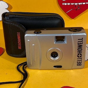 Vintage Honeywell 28mm focus free 35mm film cameras with original case and an expired roll of Kodak 400 film