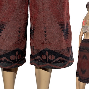 May include: Red and black patterned culottes with a geometric design. The culottes are made of a soft, woven fabric.