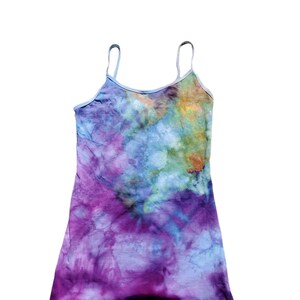 Puede incluir: Un top de tirantes teñido anudado con un esquema de color morado, azul y verde. El top tiene tirantes finos y un escote redondo.