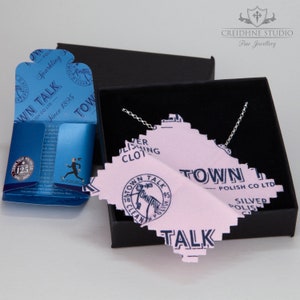 May include: A silver chain necklace in a black box with a pink polishing cloth that says "Town Talk Polish Co. Ltd." and "Silver Polish".