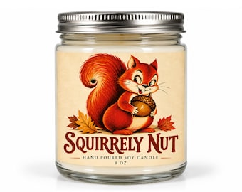 May include: A clear glass jar candle with a silver metal lid containing white wax. The label features a red squirrel holding an acorn, surrounded by autumn leaves, with the text SQUIRRELY NUT, HAND POURED SOY CANDLE, and 8 OZ printed below.