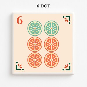 May include: Square tile with a cream background featuring the number 6 in orange and six stylized fruit slice illustrations in teal and orange. The text "6 DOT" is at the top. Decorative green and red corner accents complete the design.