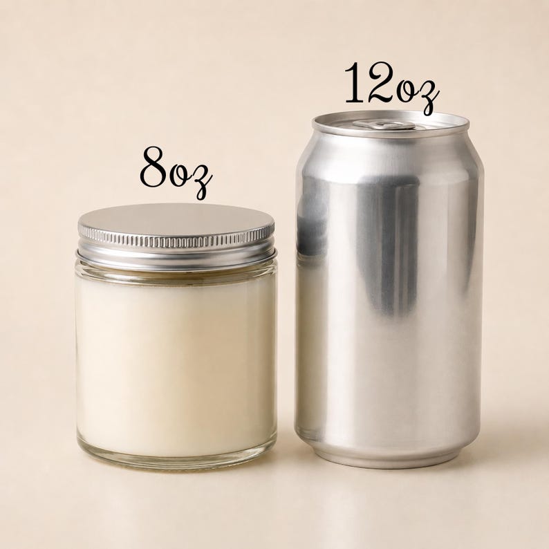May include: A clear glass candle jar with a silver metal lid labeled 8oz, positioned next to a silver aluminum beverage can labeled 12oz. The candle jar contains a solid off-white wax, and both items are displayed side by side for size comparison.