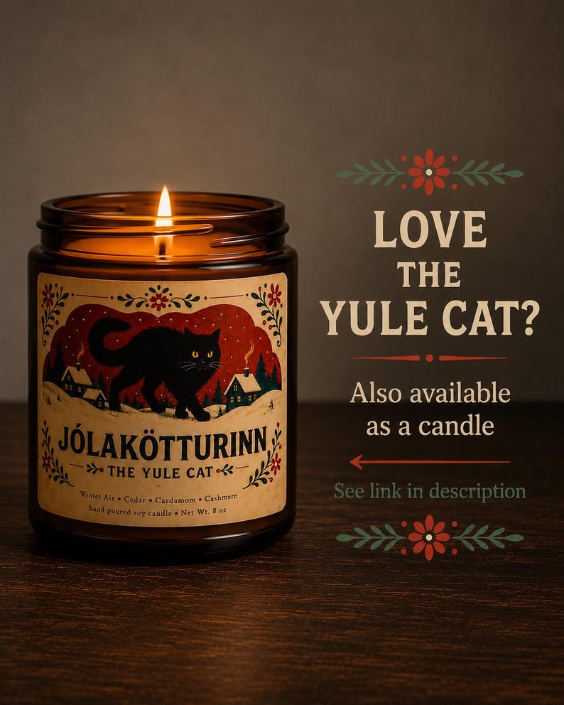 May include: A lit soy candle in an amber glass jar with a label featuring a black cat, snowy houses, and the text J&Oacute;LAK&Ouml;TTURINN THE YULE CAT. The label lists Winter Air, Cedar, Cardamom, and Cashmere scents with a net weight of 8 oz.
