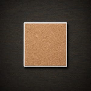 May include: A square coaster featuring a natural light brown cork surface set within a clean white border. The coaster has a flat, uniform texture and a simple geometric shape, providing a neutral base for various types of drinkware and containers.