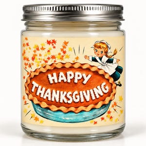 May include: A clear glass candle jar with a silver metal lid containing white wax. The label features a large brown pie in a blue dish with the text HAPPY THANKSGIVING in white, surrounded by orange and yellow autumn leaves and a cartoon child.