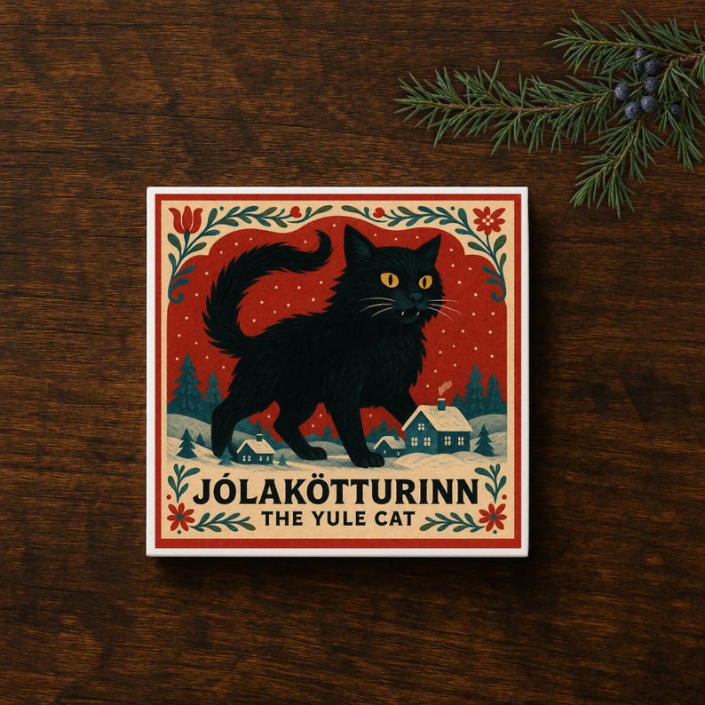 May include: A square decorative tile featuring a black cat illustration against a red background with white snowflakes, small houses, and pine trees. The text reads J&Oacute;LAK&Ouml;TTURINN THE YULE CAT in black capital letters with floral border accents.
