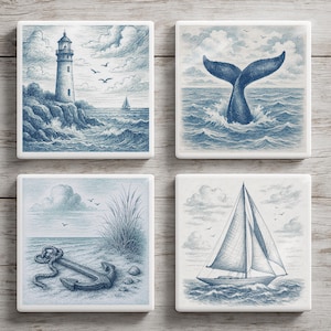 May include: Four square ceramic coasters with blue and white nautical illustrations. Designs include a lighthouse, whale tail, anchor on a beach, and a sailboat. The coasters are arranged on a light wood grain surface.