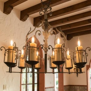 May include: A white ceramic mug with a black handle and the text "But First, Coffee" in a bold, black font. The mug is set against a blurred background, suggesting a cosy setting.