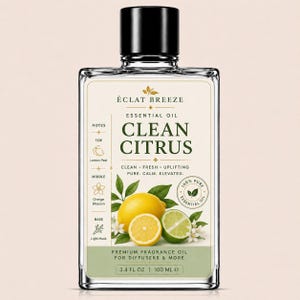 May include: A clear glass bottle of Éclat Breeze Clean Citrus essential oil. The label features a lemon and lime illustration, with text indicating the oil is 100% pure. The bottle contains 3.4 fl oz, equivalent to 100 ml.