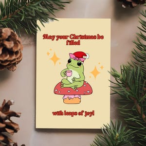 Linda tarjeta navideña con forma de rana y hongo saltando de alegría, divertidas tarjetas de felicitación navideñas, papelería de temporada, notas de regalo festivas