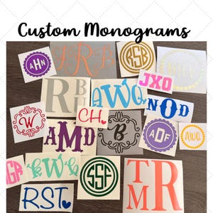 May include: A collection of custom vinyl monogram decals in various colors, fonts, and styles, including circular, floral, and script designs. The decals feature letters such as AHN, IRB, RSB, MFB, JXO, W, R, B, AWQ, CH, AMD, B, ADF, GR, KW, SSF, TR, M, R, and RST, displayed on white backing paper.