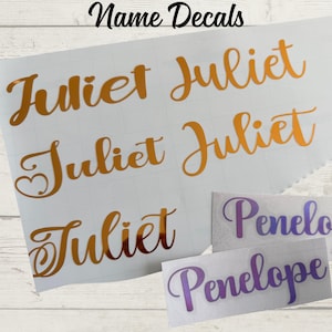 May include: Holographic and chrome name decals in various fonts. The name "Juliet" is displayed in gold, and "Penelope" in purple. The text "Lots of Fonts & Vinyl Choices" is also visible.