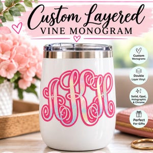 May include: A white stainless steel tumbler featuring a custom layered vine monogram in iridescent holographic vinyl. The text at the top reads Custom Layered VINE MONOGRAM, with additional icons and text detailing double layer vinyl and options.