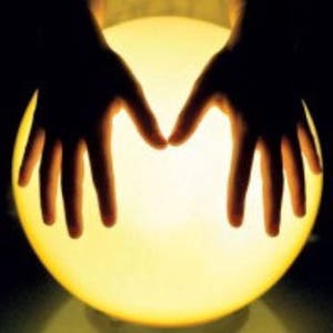 May include: Two hands cupped around a glowing orb, creating a mystical and ethereal effect.