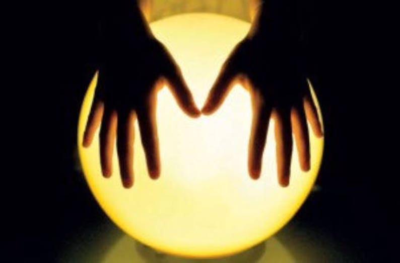 May include: Two hands cupped around a glowing orb, creating a mystical and ethereal effect.
